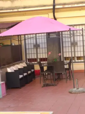 a pink umbrella sitting on top of a patio at YourStay@Rome Vatican in Rome
