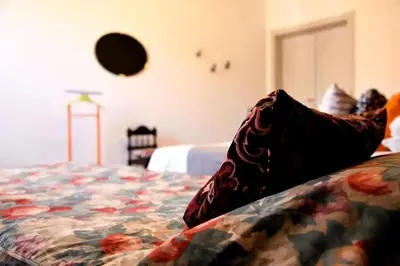 a close up of a bed with a flowered blanket at Heartwarming Apartment in ROMA - 5 Minutes from Colosseum in Rome