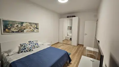 a bedroom with a bed and a painting on the wall at La casa di Lele in Rome