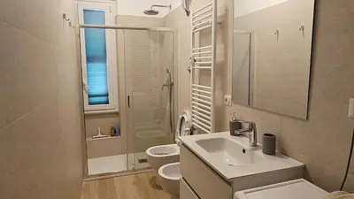 a white bathroom with a sink and a toilet at La casa di Lele in Rome