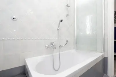 a white bathroom with a shower and a bath tub at Bright Vatican 2 bedroom Apartment in Rome