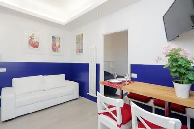 a living room with a white couch and a table at Bright Vatican 2 bedroom Apartment in Rome