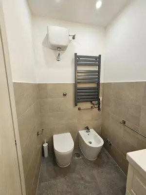 a bathroom with a toilet and a sink at You'RhomeSuite in Rome