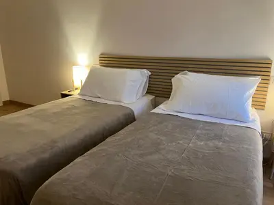 a living room with a blue couch and a lamp at You'RhomeSuite in Rome