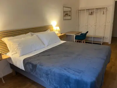 a large wooden door in a stone building at You'RhomeSuite in Rome