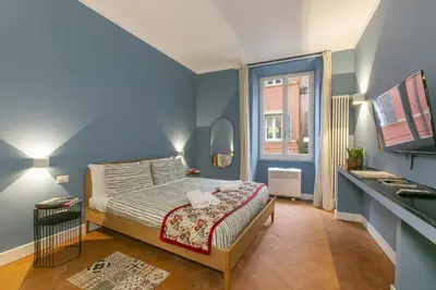 a bedroom with a bed in a blue room at Home Baccina 28 in Rome