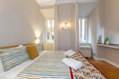 a bedroom with a large bed with towels on it at Home Baccina 28 in Rome