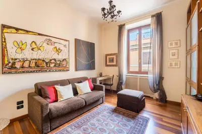 a living room with a couch and a window at Dimora Esedra, Historical Flat in the Heart of Rome in Rome