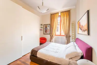 a bedroom with a bed and a window at Dimora Esedra, Historical Flat in the Heart of Rome in Rome