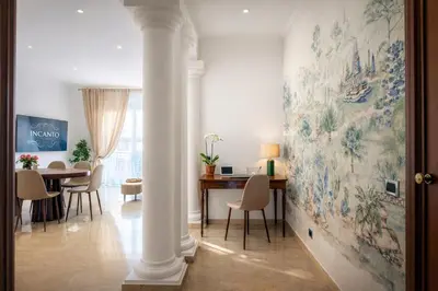 a bedroom with a white bed with blue walls and trees at Casa Incanto - Luxury Vatican Apartment in Rome