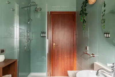 a bathroom with a white sink and a window at Casa Incanto - Luxury Vatican Apartment in Rome