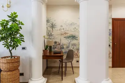 a room with a table and a wall mural at Casa Incanto - Luxury Vatican Apartment in Rome