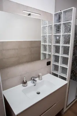 a bathroom with a white sink and a mirror at Ostiense 73 in Rome