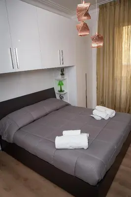 a bedroom with a bed with towels on it at Ostiense 73 in Rome