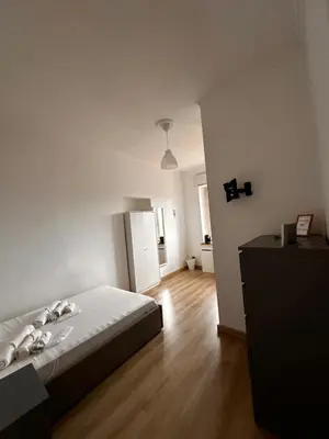 a white kitchen with a desk and a window at Porta Maggiore room in Rome