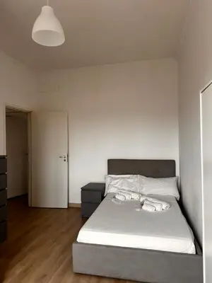 a bedroom with a bed and a cabinet in it at Porta Maggiore room in Rome