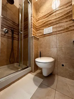 a bedroom with a bed and a wooden floor at Porta Maggiore room in Rome