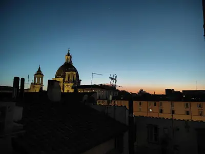 a view of the roofs of a city at sunset at Appartamento Lilly's Home Piazza Navona in Rome