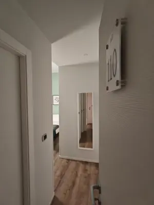 a room with a hallway with a clock on the wall at AD 111 ColaDiRienzo Rooms - by AD Roma in Rome