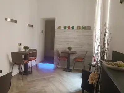 a dining room with two tables and two chairs at AD 111 ColaDiRienzo Rooms - by AD Roma in Rome