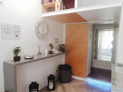 a room with a door and a clock on the wall at AD 111 ColaDiRienzo Rooms - by AD Roma in Rome