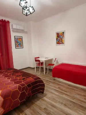 a bedroom with a bed and a table with chairs at Room CasaVostrA 2 in Rome