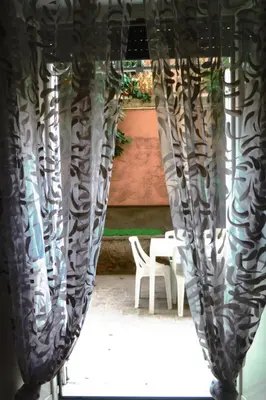 a glass sculpture with a table and a white chair at Room CasaVostrA 2 in Rome