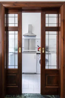 an open door to a kitchen with a stove at ULPIANO SUITE Vaticano Centro in Rome