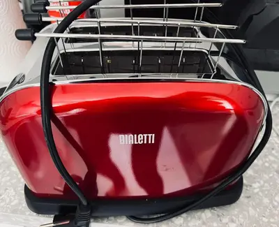 a red car with a hose attached to it at ULPIANO SUITE Vaticano Centro in Rome