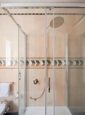 a shower with a glass door in a bathroom at ULPIANO SUITE Vaticano Centro in Rome