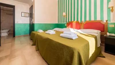 a hotel room with two beds and a bathroom at Hotel Center 3 in Rome