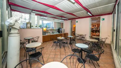 a room with tables and chairs in a restaurant at Hotel Center 3 in Rome