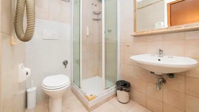 a bathroom with a shower and a toilet and a sink at Hotel Center 3 in Rome