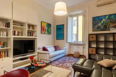a living room with a couch and a tv at JOIVY Charming 3BR flat near the Vatican in Rome