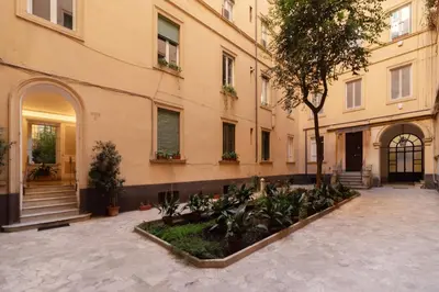 an empty courtyard in front of a building at JOIVY Charming 3BR flat near the Vatican in Rome