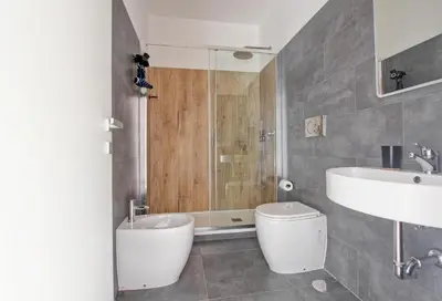 a bathroom with a toilet and a sink and a shower at Marble Rooms in Rome