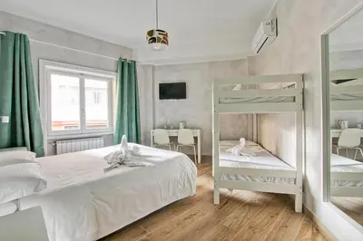 a bedroom with two bunk beds and a table at Marble Rooms in Rome