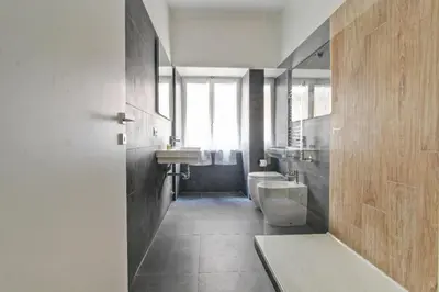 a bathroom with a sink and a urinal and a toilet at Marble Rooms in Rome