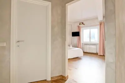 a white room with a bed and a window at Marble Rooms in Rome