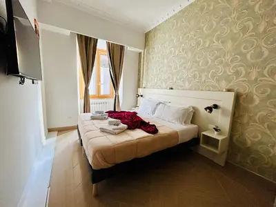 a bedroom with a bed with a red dress on it at Domus Giolitti in Rome