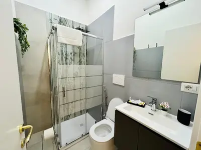 a bathroom with a toilet and a sink and a shower at Domus Giolitti in Rome