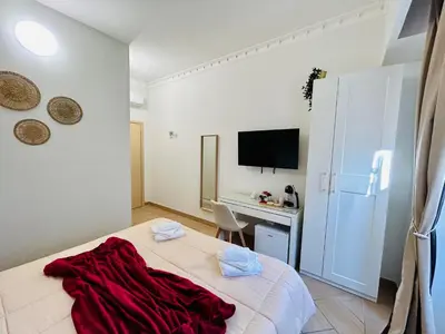 a bedroom with a bed and a desk in it at Domus Giolitti in Rome