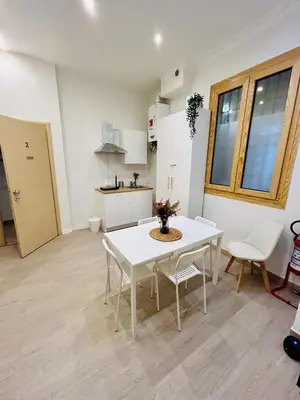 a kitchen and dining room with a table and chairs at Domus Giolitti in Rome