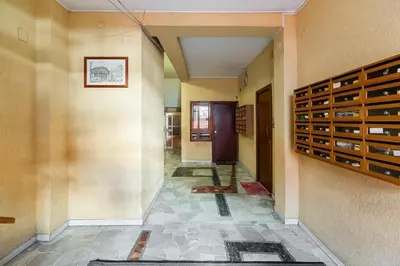 a hallway of a home with a wall with empty wine racks at Casa San Paolo in Rome