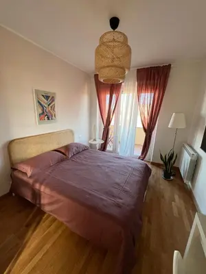 a bedroom with a large bed and a window at San Paolo Corner in Rome