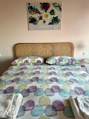 a bed with a comforter and a pillow on it at San Paolo Corner in Rome