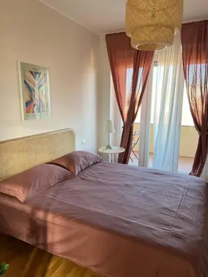 a bedroom with a large bed with a purple blanket at San Paolo Corner in Rome
