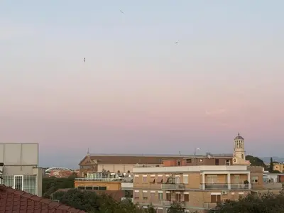 a city skyline with buildings and a clock tower at San Paolo Corner in Rome
