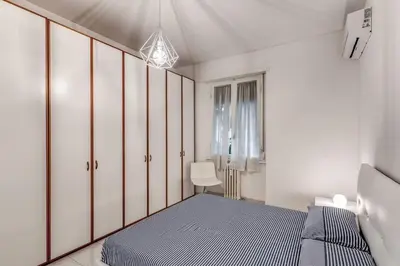 a bedroom with white cabinets and a blue bed at Nina's Apartment with terrace Rome Monteverde in Rome