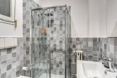 a bathroom with a shower and a sink at Nina's Apartment with terrace Rome Monteverde in Rome